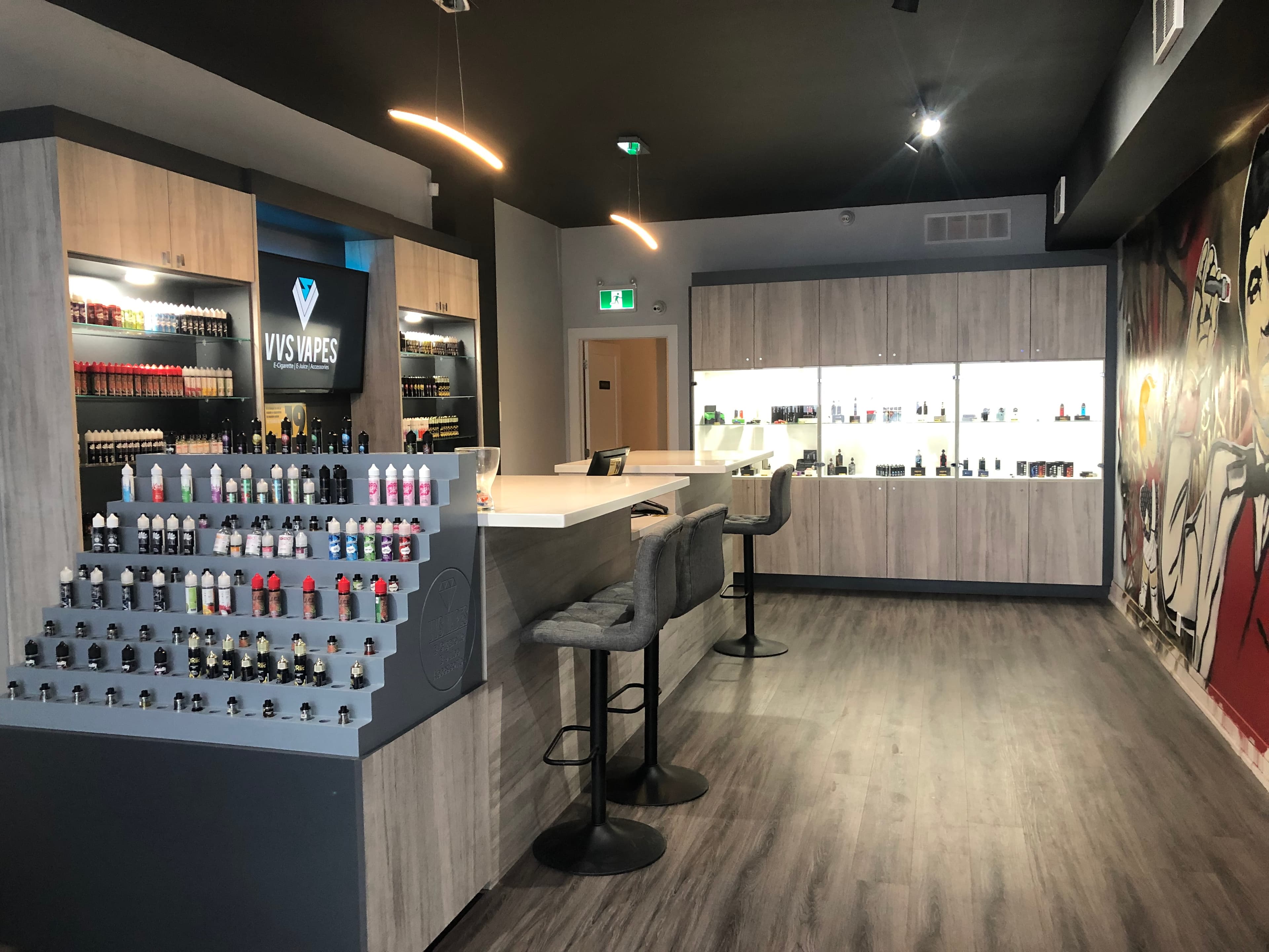 VVS Vapes retail counter with bar stools and product displays